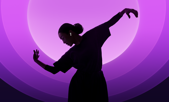 En person som dansar med AirPods 5 i öronen mot en bakgrund i olika färger
