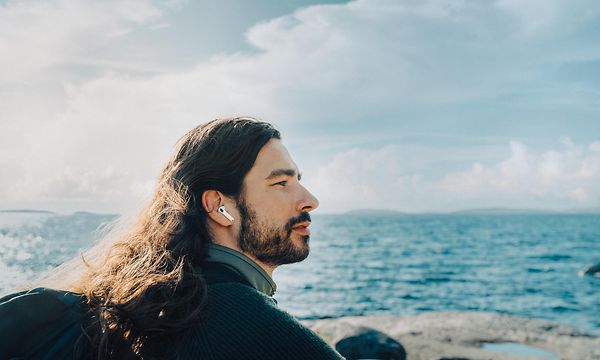 Man on the beach with AirPods Pro in his ears