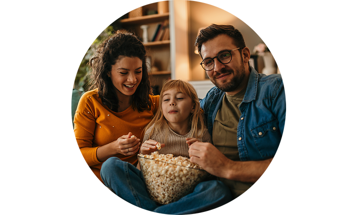 Man, woman and girl eating popcorn